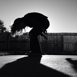 Side view of silhouette man against sky