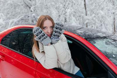 Portrait of young woman in car