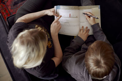 Mother helping son with homework