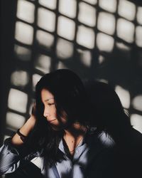 Smiling woman looking away against wall