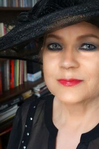 Close-up portrait of young woman in hat