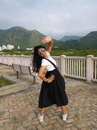 Full length of young woman sitting on steps