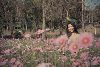 Young woman with flowers on tree