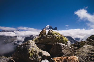 Low angle view of rocks against blue sky