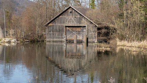 Wooden boat house on the river bank