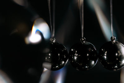 Close-up of illuminated newton pendulum balls