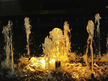 Close-up of water splashing in illuminated at night