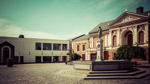 Building by street against sky