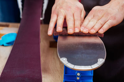 Cropped hand of man holding coffee on table