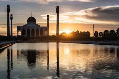 Reflection of building in lake at sunset