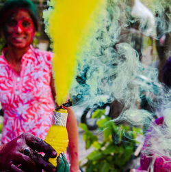 Close-up of woman with multi colored blurred background