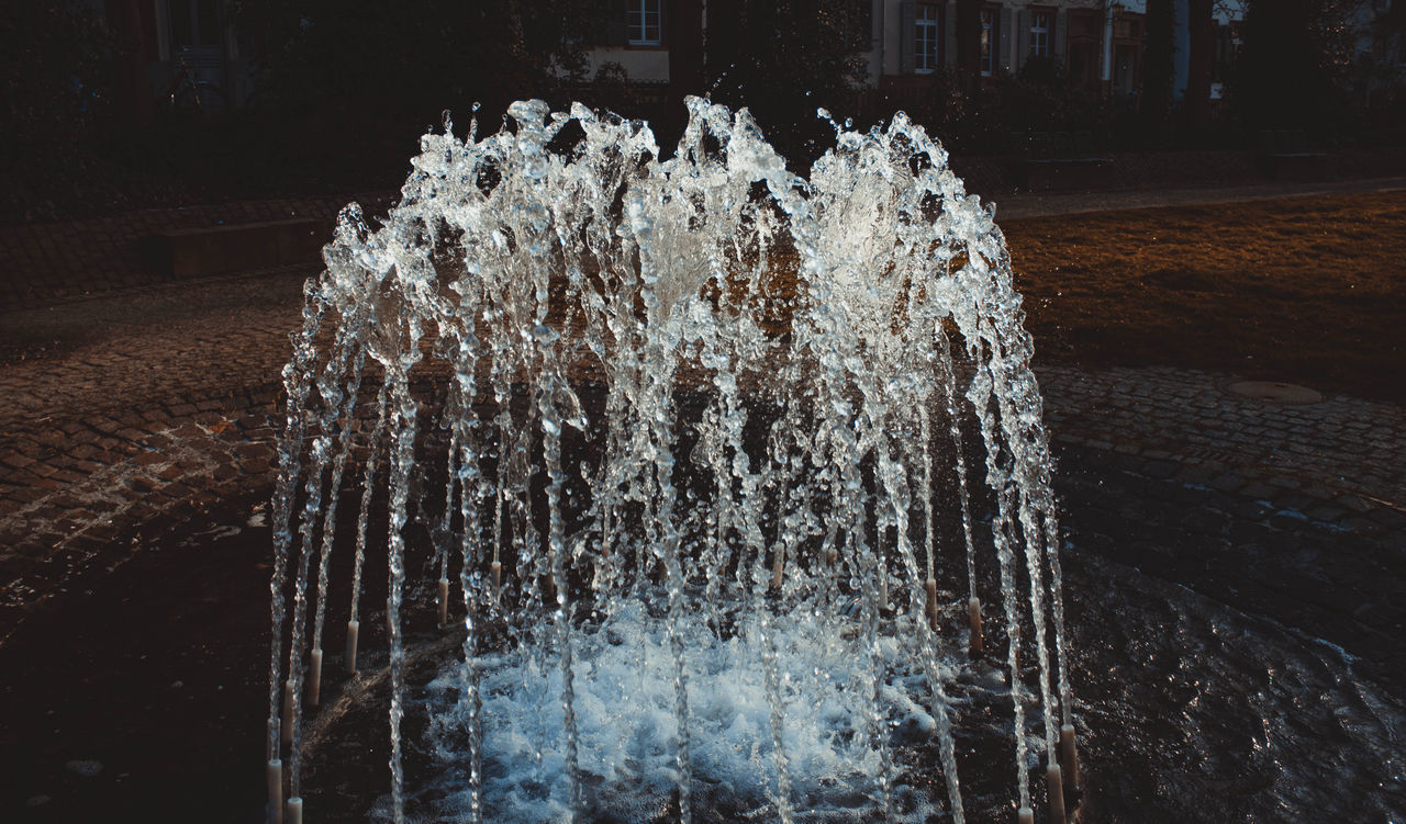 CLOSE-UP OF WATER SPLASHING FOUNTAIN