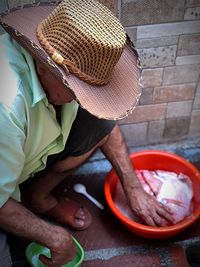 High angle view of man cleaning seafood