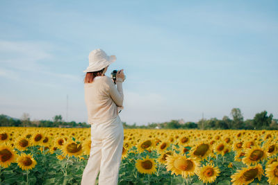 Full length of sunflower on field against sky