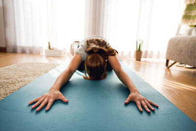 Young woman lying on floor at home