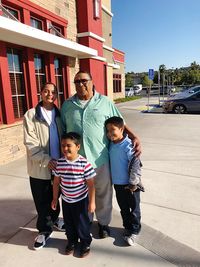 Full length of family on sidewalk