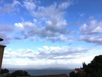 Panoramic view of trees against blue sky