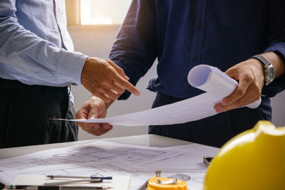 Rear view of man working on table