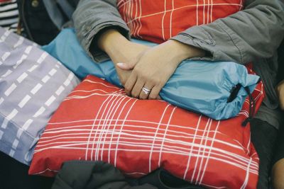 Midsection of woman holding bag