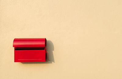 Close-up of red mailbox on wall