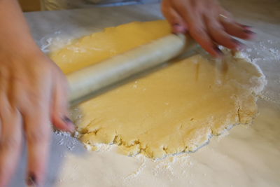 Cropped image of person preparing food in kitchen