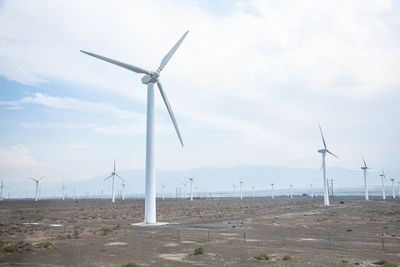 Windmill on field against sky