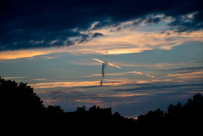 Silhouette trees against sky during sunset