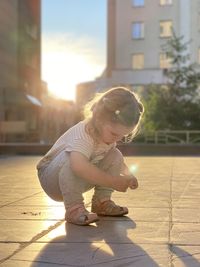 Cute girl looking at camera on sunny day