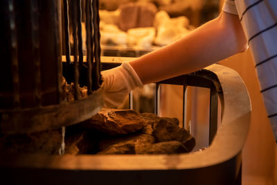 Midsection of woman preparing food in kitchen