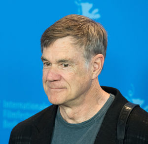 Close-up portrait of man against blue sky