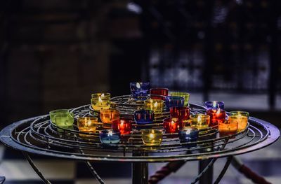 Close-up of illuminated tea lights on stand