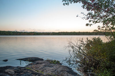 Scenic view of lake against clear blue sky