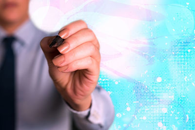 Midsection of man using mobile phone