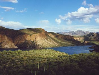 Calm lake against countryside landscape