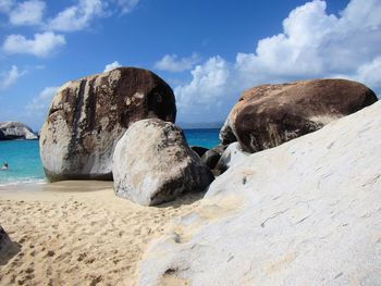 Rocks on beach against sky