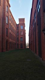 Alley amidst buildings against sky in city