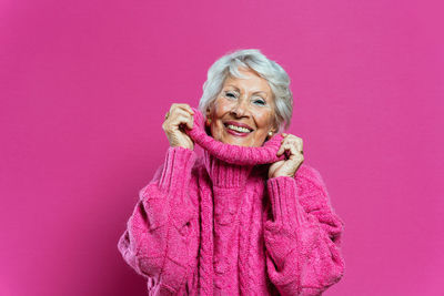 Low angle view of young woman against yellow background