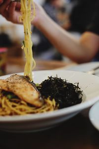 Close-up of hand in plate