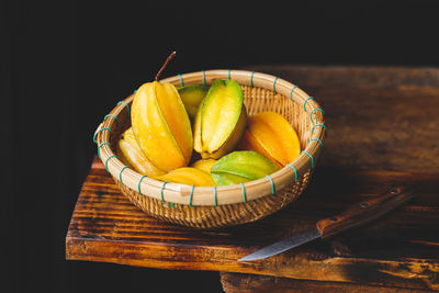 Close-up of fruits in basket on table