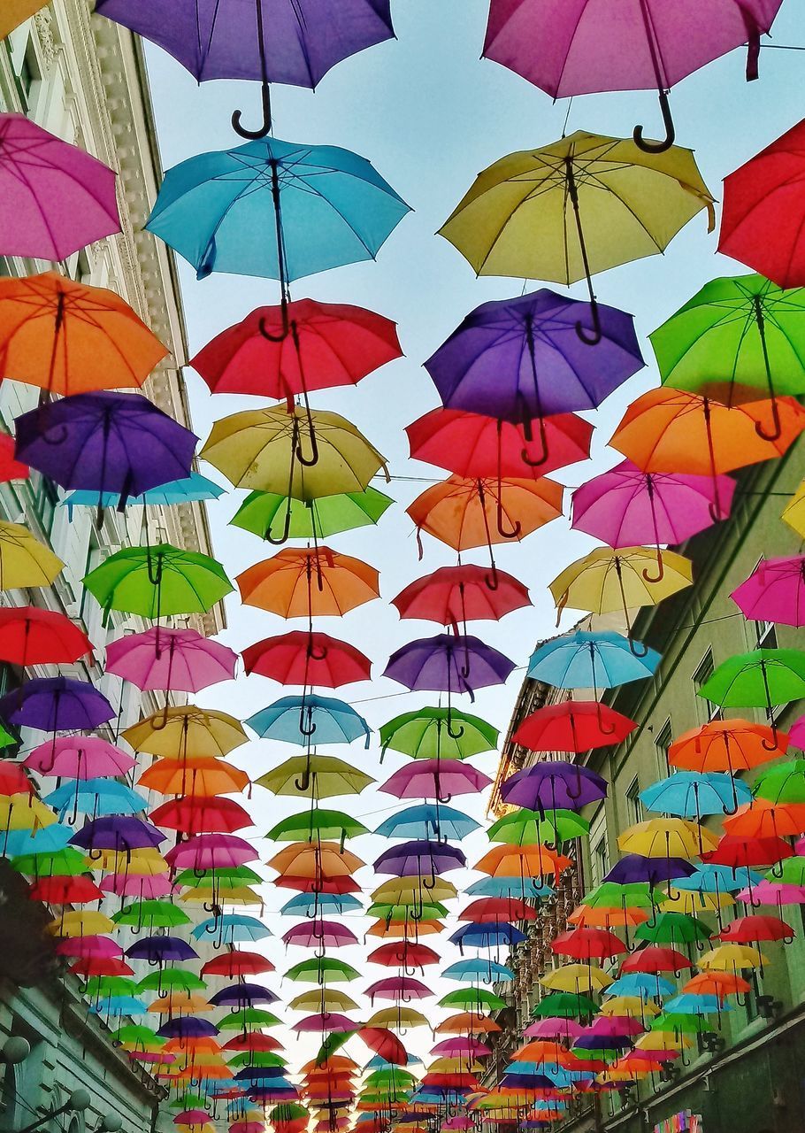 LOW ANGLE VIEW OF UMBRELLAS HANGING AGAINST CEILING