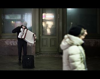 Rear view of people looking at subway station