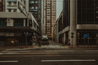 Road by buildings in city