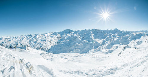 Scenic view of snow covered mountains against sky