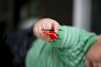 Close-up of boy playing with toy at home