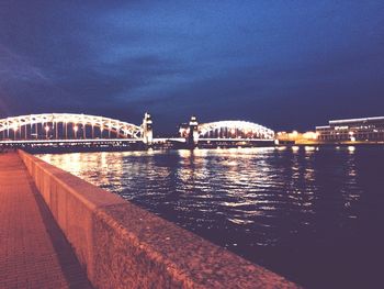 Suspension bridge over river at dusk