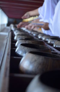 Close-up of wooden bowls in row at temple
