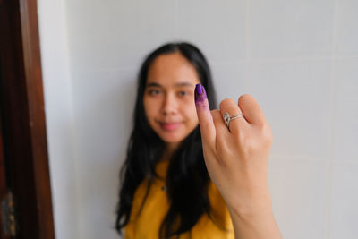 Close-up of woman with ink on fingers