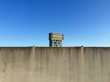 Low angle view of buildings against clear blue sky