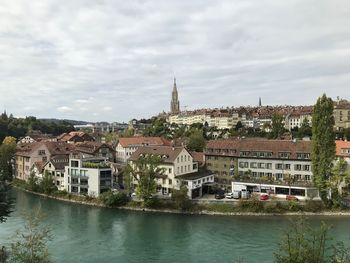 River amidst buildings against sky in city