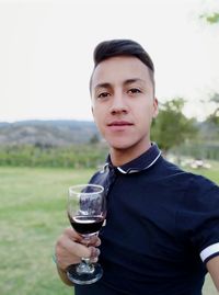 Portrait of young man drinking glasses